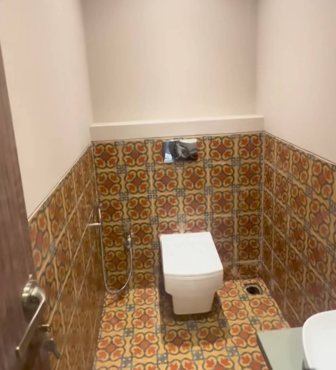 Bathroom with mosaic patterned tiles floor and walls